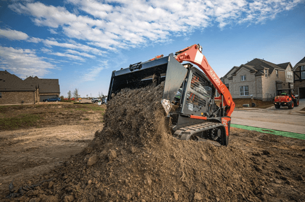 Track Loader dumping dirt onto pile