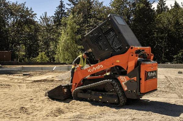 Man getting into his track loader