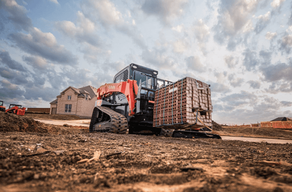 Track Loader moving pallet of bricks