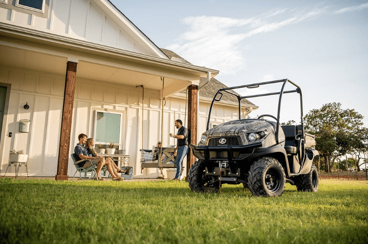 People hanging out on a porch with RTV parked in the front