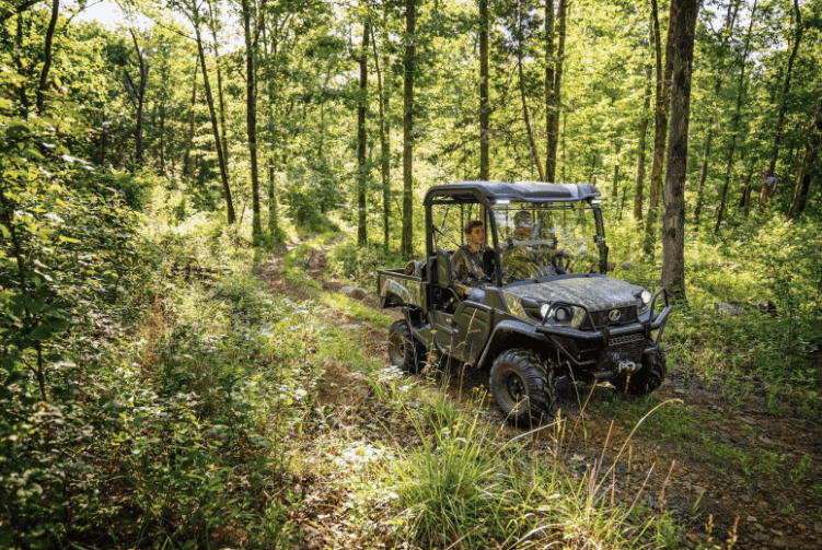 RTV driving through a wooded trail