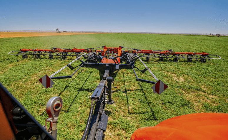 Rake collecting grass into piles