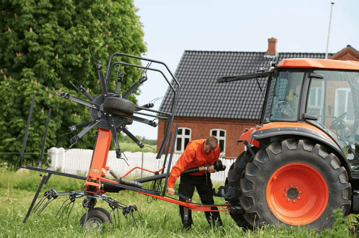 Tedder attached to back of tractor