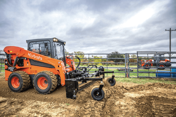 Skid steer using front attachment to level ground