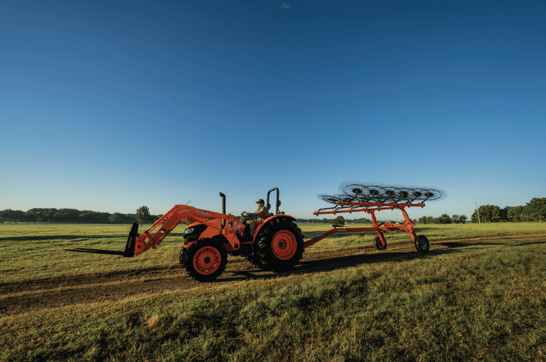 Weel rake attached to rear of tractor