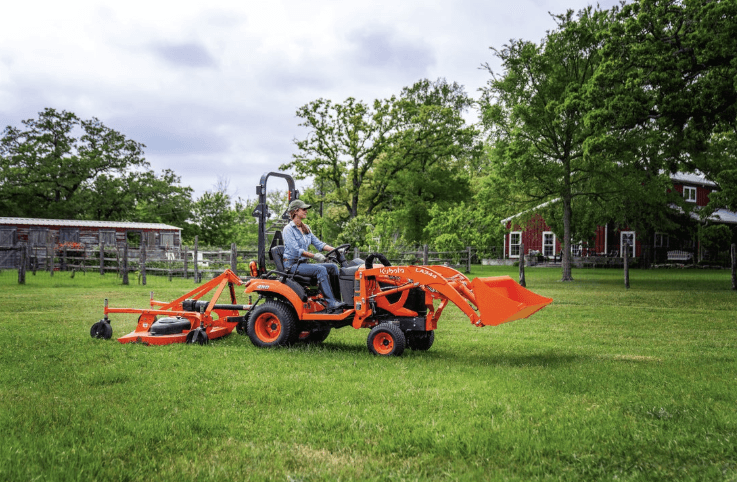 Woman using Lineup of Compact Tractor to mow her yard