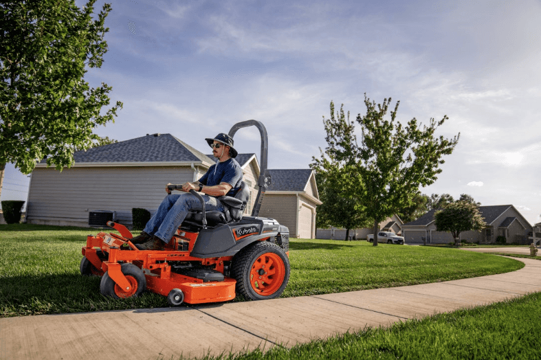Man mowing lawn with a zero-turn mower