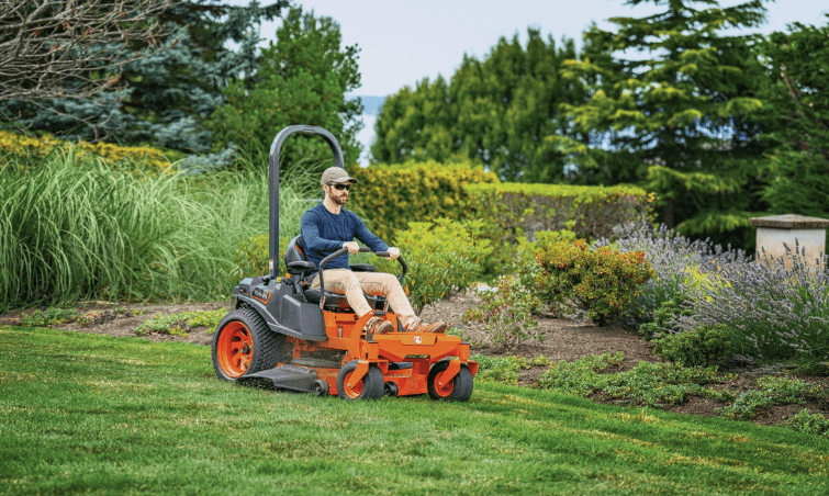 Man mowing lawn with a zero-turn mower