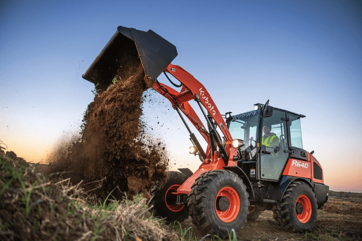Wheel Loader dumping dirt onto piles