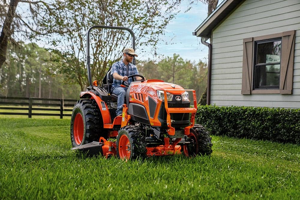 Man using mid mount mower to mow lawn