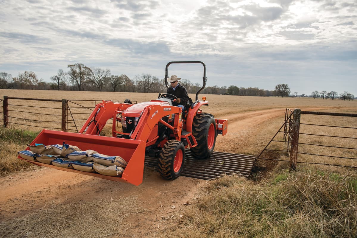 Tractor moving heavy materials in front loader