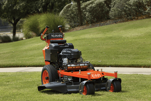 Walk-behind mower staged on a perfectly manicured lawn