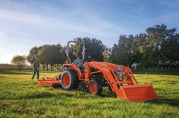 Man walking behind tractor