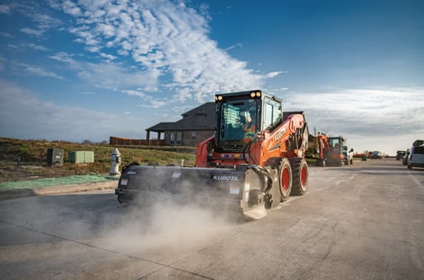 Skid Steer with sweeper attachment