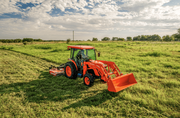 Tractor mowing lawn with rear mower
